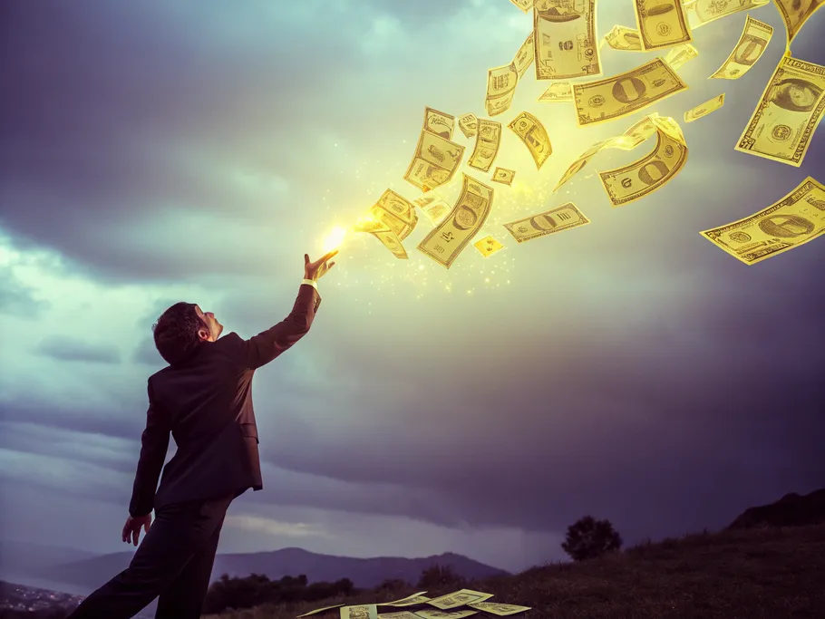 A businessman reaching for floating cash bills in a dramatic dark setting.